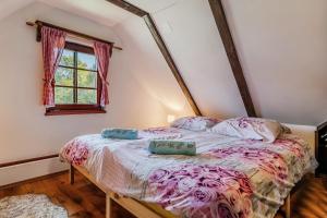 a bedroom with a bed with two pillows on it at Nature Lodge With Sauna and Hot Tub - Happy Rentals in Tužno