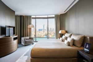 a hotel room with a bed and a television at Armani Hotel Dubai, Burj Khalifa in Dubai
