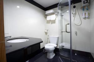 a bathroom with a toilet and a sink and a shower at Vince Sakon in Sakon Nakhon