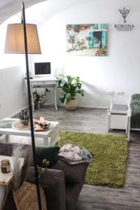 a living room with a couch and a table at Korona Apartman Székesfehérvár in Székesfehérvár