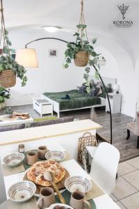 a room with a table with a pizza on it at Korona Apartman Székesfehérvár in Székesfehérvár