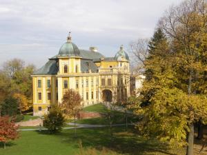 a large yellow mansion with a green roof at Hotel Park in Našice