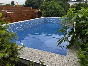 a swimming pool with blue water in a garden at 寧靜の家A區14人Villa專暑獨棟隱私無憂 in Hengchun South Gate +48 photos