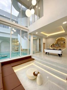 a living room with a pool table and a couch at The Pool Space - ICONIC Pool Villa in Ban Huai Yai