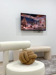 a living room with a tv on a wall at The Pool Space Pool Villa Pattaya A2 พูลวิลล่า in Ban Huai Yai