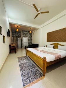 a bedroom with a large bed with a ceiling fan at Victus Emporium in Guwahati +26 photos