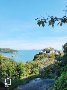 a view of the ocean from a hill at ist villa 05 Mountain Hideout Sleeps 3 in Wada +9 photos