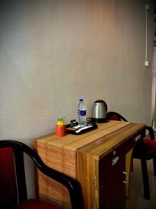 a table with a bottle of water on top of it at Victus Emporium in Guwahati