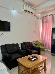 a living room with a couch and a table at Victus Emporium in Guwahati