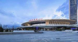 a large building with people sitting on top of it at Xana Hotelle· Wulumuqi High Speed Railway Station Baonengcheng in Ürümqi