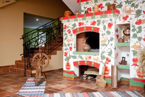 a room with a gingerbread house with a fireplace at Russkaya Derevnya in Vladimir