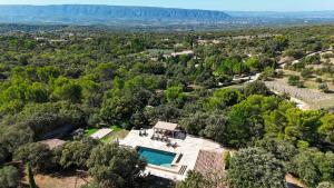 an aerial view of the house with a swimming pool and trees at Stunning Stone House With Pool Near Gordes in Gordes