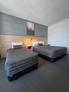 a hotel room with two beds in a room at The Sands Motel Adelaide in Adelaide