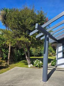 a blue bench sitting outside of a building at Fisherman's Friend - a spacious family beach home in Pohara