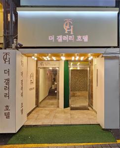 an entrance to a building with a sign on it at 더 갤러리 호텔 in Suwŏn-yŏk