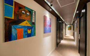 a hallway with paintings on the walls of a building at 더 갤러리 호텔 in Suwŏn-yŏk +5 photos