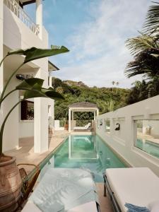 a house with a swimming pool and a patio at Raes on Wategos in Byron Bay
