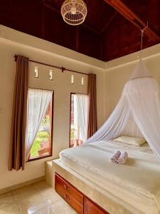 a bedroom with a bed with two towels on it at Sumatra Expedition Lodge in Bukit Lawang +48 photos
