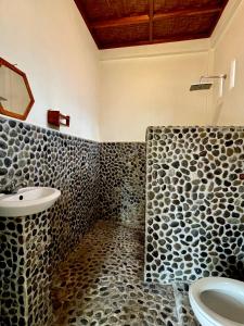 a bathroom with a sink and a toilet at Sumatra Expedition Lodge in Bukit Lawang