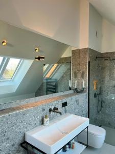 a bathroom with a white sink and a toilet at Architect's House With Nature View 