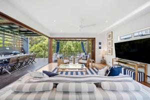 two large beds in a living room with a television at Family Beach House at Twin Waters Resort in Twin Waters +49 photos