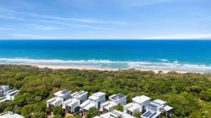 an aerial view of the beach and condos at Family Beach House at Twin Waters Resort in Twin Waters