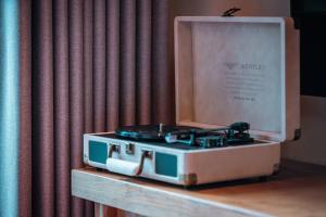 a suitcase sitting on a table next to a curtain at Sanctum Peaks in Zhangjiajie