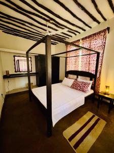 Ένα ή περισσότερα κρεβάτια σε δωμάτιο στο Villa Kazungu