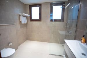 a bathroom with a shower and a toilet and a sink at Villa AZ - Hawana Salalah in Salalah +8 photos