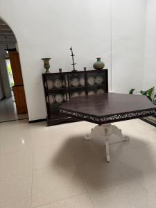 a coffee table in a living room with a cross on top at Sudu Colonial House 1929 in Ambalangoda
