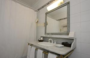 a bathroom with a sink and a mirror at Solar De La Plaza in Salta