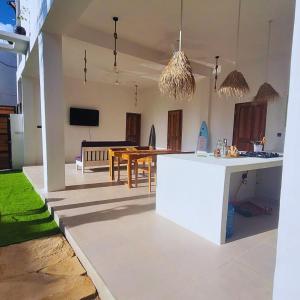 a kitchen and living room with a table and a dining room at Paje Beach Zanzibar Private Luxury Villa with pool AC WIFI TV 90m walk to beach central location walk to shops bars & restaurants in Paje