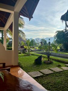 a resort with a view of a garden and mountains at Sumatra Expedition Lodge in Bukit Lawang
