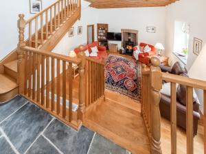 a living room with a staircase and a couch at Ty Menyn in Mathry