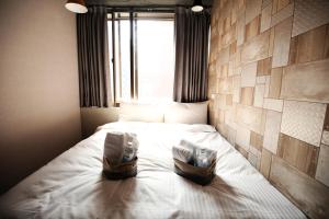 Postel nebo postele na pokoji v ubytování NYS Loft Hotel