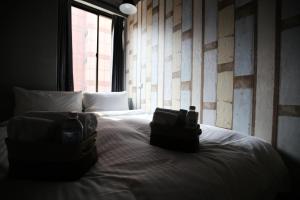 Postel nebo postele na pokoji v ubytování NYS Loft Hotel