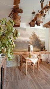 a dining room with a table and a potted plant at La Potentille in Lieuran-Cabrières