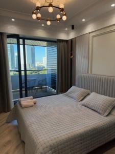 Postel nebo postele na pokoji v ubytování Апартаменты в элитном ЖК NRG U-TOWER