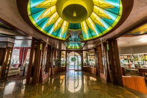 a lobby with a large stained glass ceiling at Park Hotel Per&ugrave; ***S in Lido di Jesolo