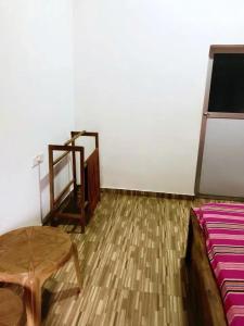 a room with a bed and a table and a mirror at Chapa Resting Place in Dickwella