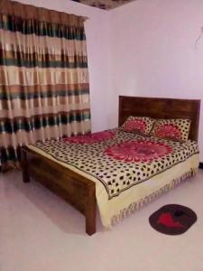 a bed sitting in a room with a curtain at Chapa Resting Place in Dickwella