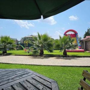 a park with a playground and a roller coaster at Keriwest hotel in Kericho