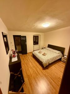 a bedroom with a bed and a wooden floor at Casa di Patti in Meleto +32 photos