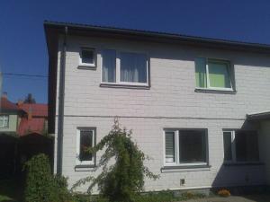 a white house with a tree in front of it at Auli Beach Area Holiday Home in Pärnu