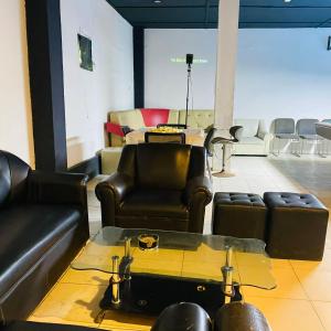 a waiting room with leather furniture and a table at BE Happy Event Lounge in Mandaue City