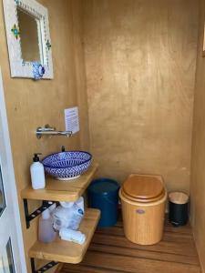 ein kleines Badezimmer mit Toilette und Waschbecken in der Unterkunft Glamping with stunning sea view in Nelson