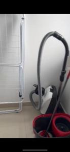 a kitchen utensils in a red bowl next to a refrigerator at Danydumbravita in Dumbrăviţa