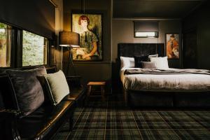 a bedroom with two beds and a couch in it at The Amalfi House in Hepburn Springs