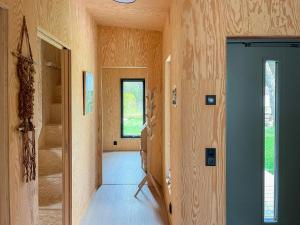 a hallway of a home with wooden walls at Architect-Designed House Near Sea On Resö in Resö