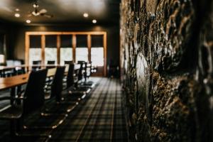 a row of chairs in a room with a wall at The Amalfi House in Hepburn Springs